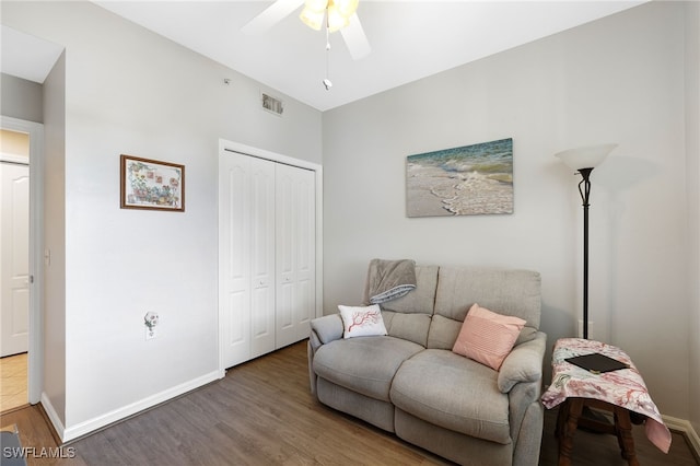 sitting room with wood-type flooring and ceiling fan