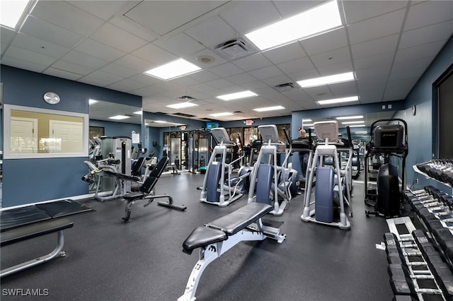 exercise room featuring a paneled ceiling