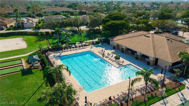 view of swimming pool featuring a yard and a patio area