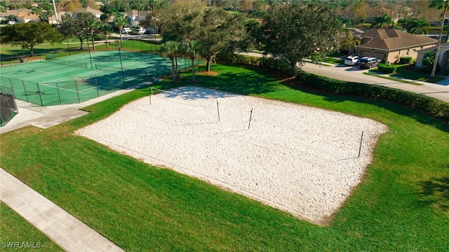 surrounding community with tennis court, a lawn, and volleyball court