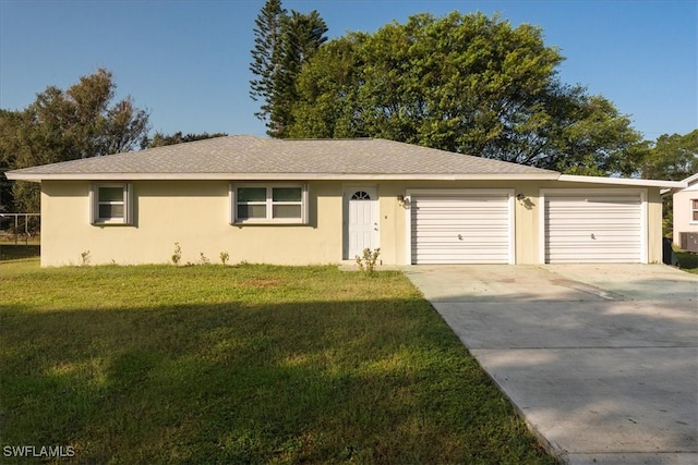 ranch-style home featuring a garage and a front lawn