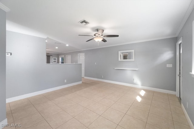 empty room featuring ceiling fan, light tile patterned floors, and ornamental molding