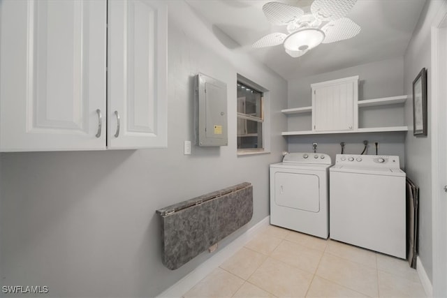 washroom featuring electric panel, washer and clothes dryer, light tile patterned floors, cabinets, and ceiling fan