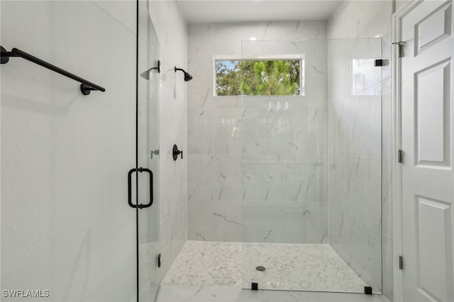 bathroom with a shower with door