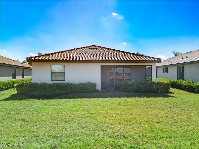 view of side of property with a yard