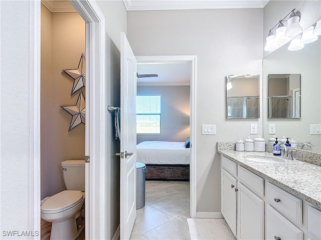 bathroom with toilet, tile patterned flooring, vanity, and crown molding