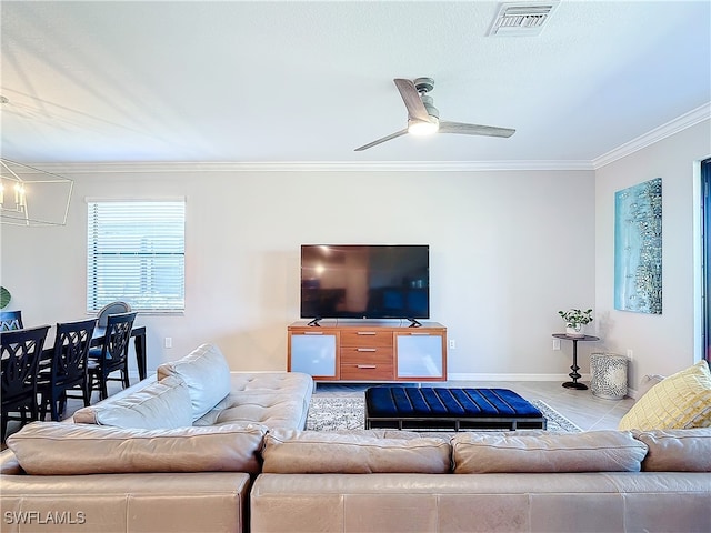 living room with ceiling fan with notable chandelier and crown molding