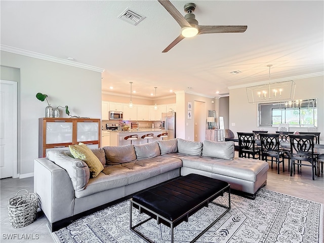 living room with ceiling fan with notable chandelier and crown molding