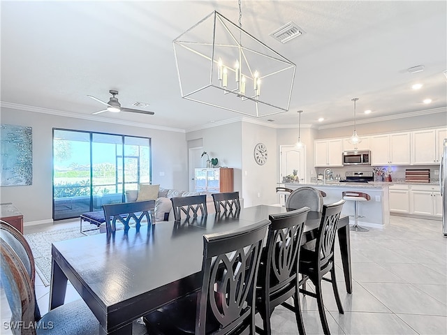 dining space featuring light tile patterned floors, ornamental molding, and ceiling fan with notable chandelier