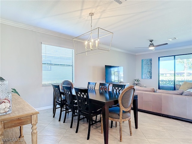 tiled dining area with ornamental molding and ceiling fan with notable chandelier