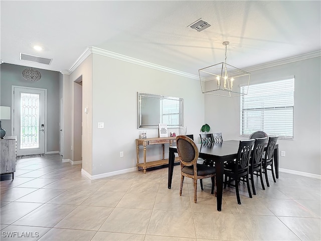 dining room with a chandelier, crown molding, and light tile patterned floors