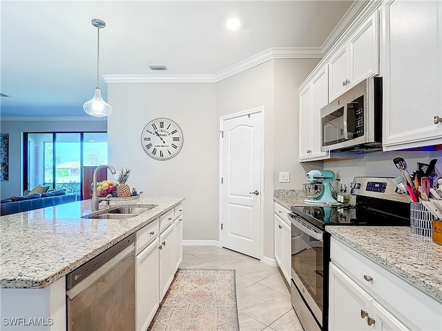 kitchen with ornamental molding, a center island with sink, white cabinetry, appliances with stainless steel finishes, and sink