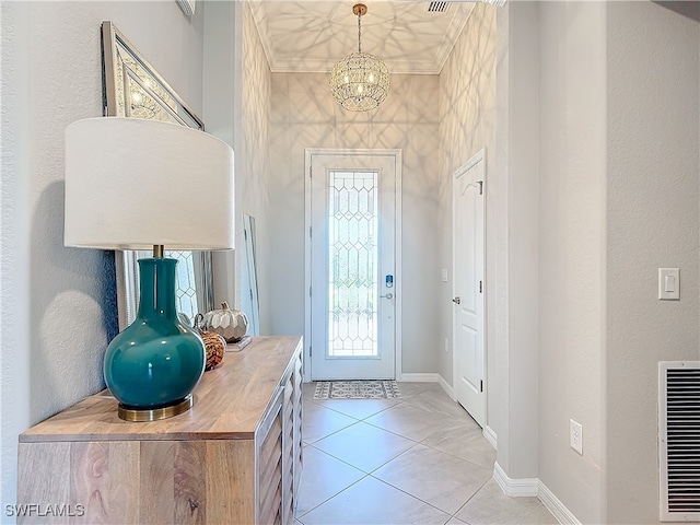 tiled foyer featuring a chandelier