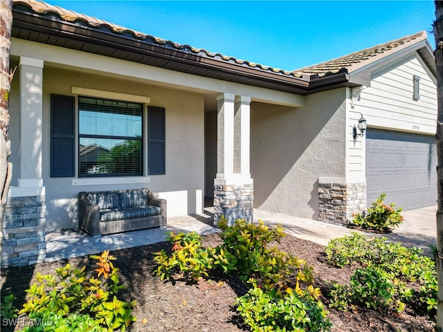 doorway to property with a garage