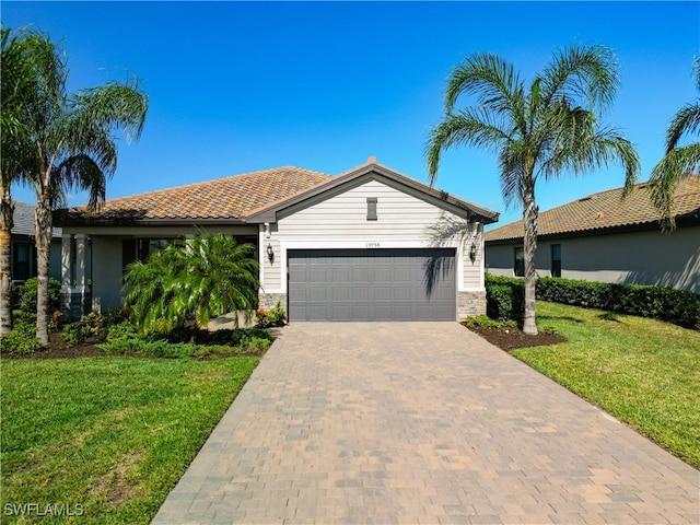 view of front of property featuring a garage and a front lawn