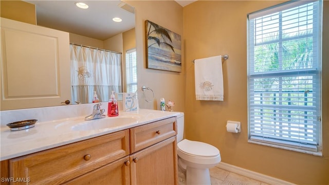 bathroom featuring tile patterned flooring, vanity, and toilet