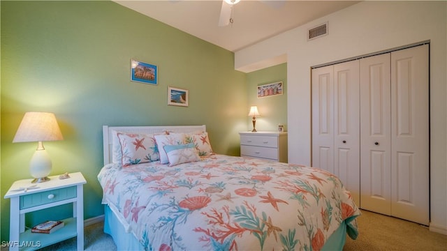 carpeted bedroom with a closet and ceiling fan