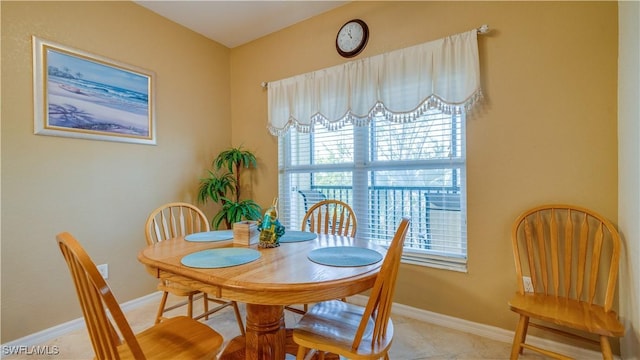 dining space with tile patterned floors