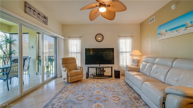 tiled living room with ceiling fan and a healthy amount of sunlight