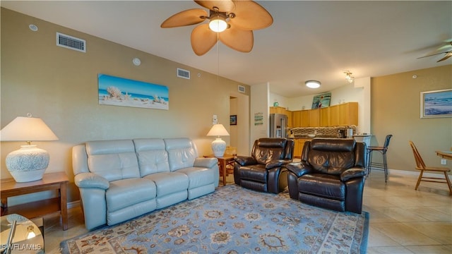 living room with ceiling fan and light tile patterned floors