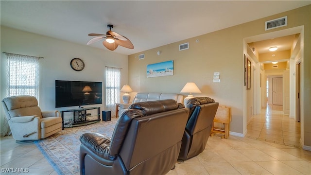 living room featuring ceiling fan and light tile patterned floors