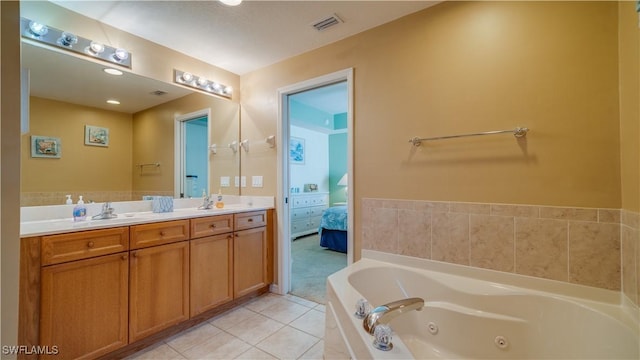 bathroom featuring tile patterned floors, a bathtub, and vanity