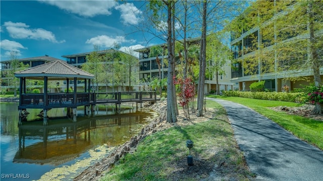 view of home's community featuring a gazebo, a lawn, and a water view