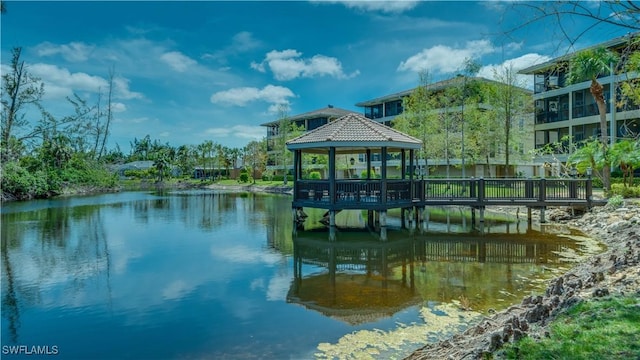 view of dock with a gazebo and a water view