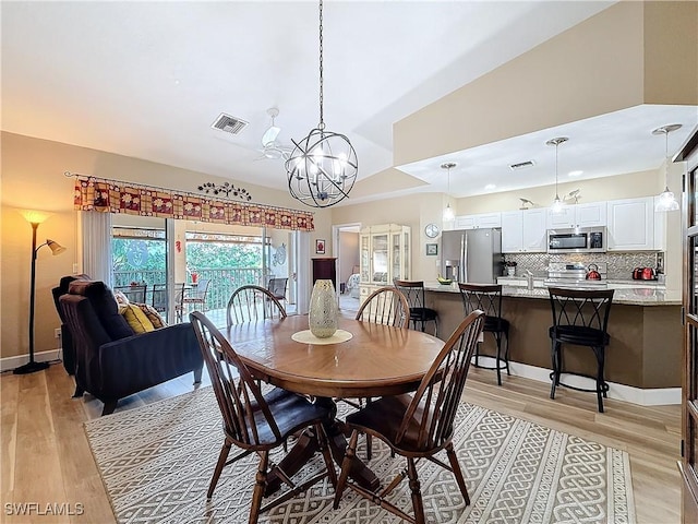 dining space featuring a chandelier and light wood-type flooring