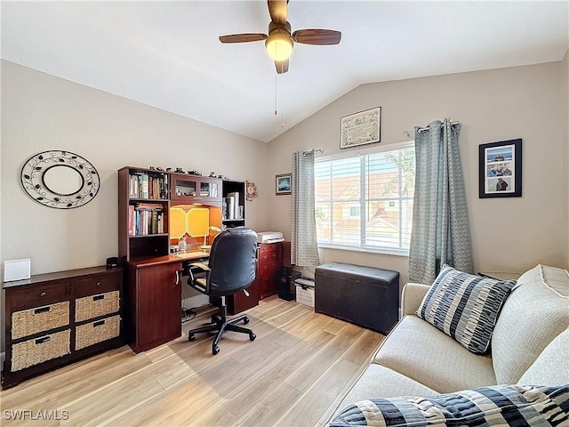 home office featuring lofted ceiling, light hardwood / wood-style floors, and ceiling fan