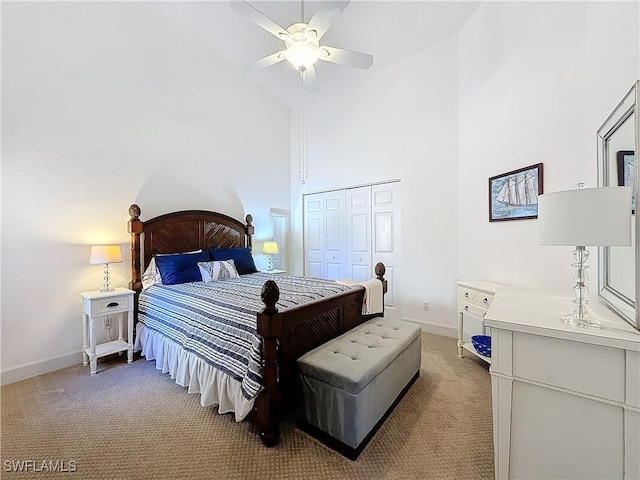 bedroom featuring high vaulted ceiling, a closet, ceiling fan, and carpet flooring