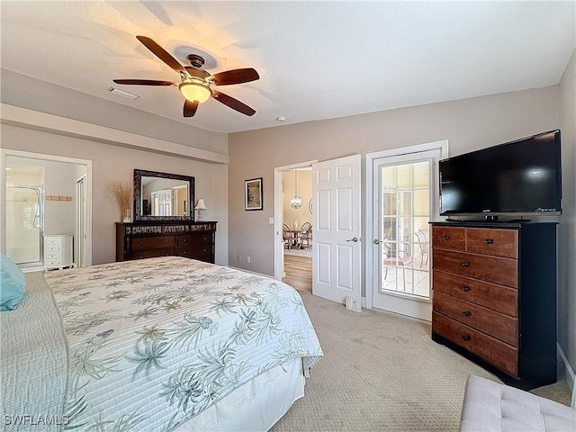 bedroom featuring ceiling fan, light colored carpet, and connected bathroom