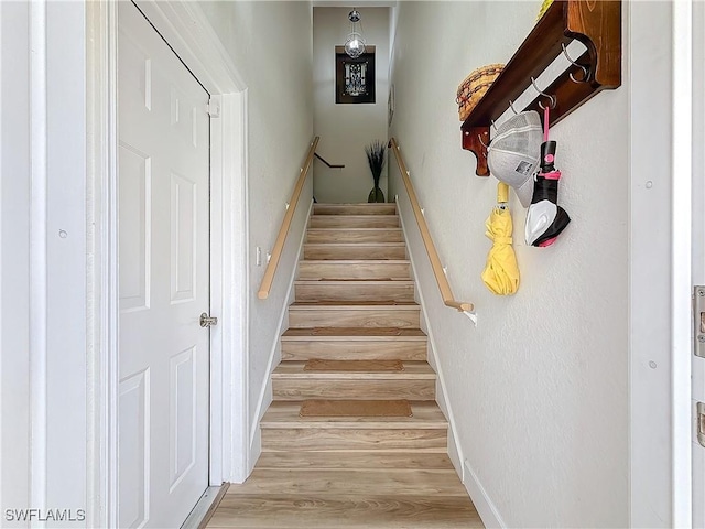 stairway featuring hardwood / wood-style flooring