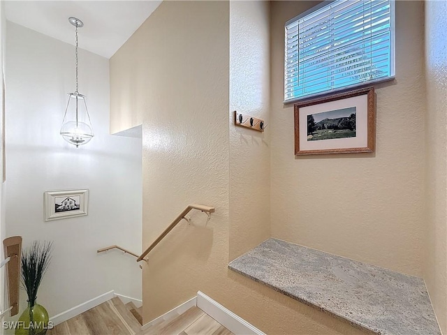 stairs featuring wood-type flooring