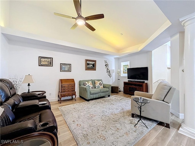 living room featuring vaulted ceiling, ceiling fan, decorative columns, and light hardwood / wood-style flooring