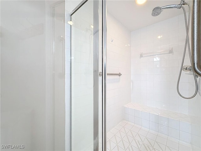 bathroom with a shower with door