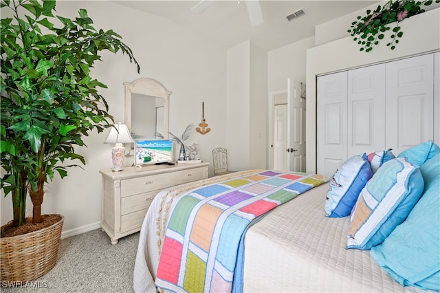 bedroom featuring ceiling fan, a closet, and light carpet