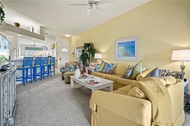 living room with ceiling fan and carpet flooring