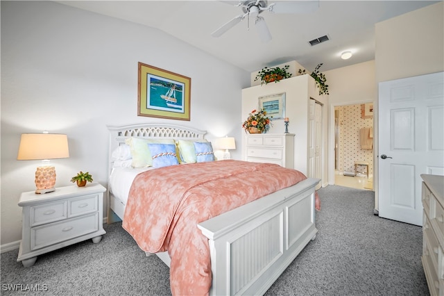 bedroom with ceiling fan, carpet, ensuite bathroom, and lofted ceiling