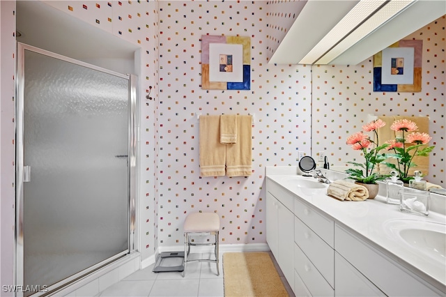 bathroom featuring a shower with door, vanity, and tile patterned flooring