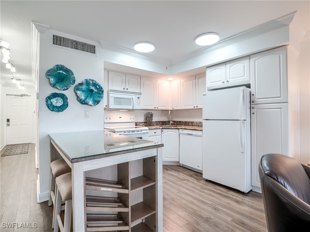 kitchen featuring white cabinetry, light hardwood / wood-style floors, and white appliances