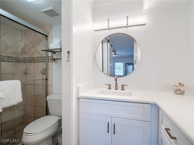 bathroom with walk in shower, vanity, and toilet