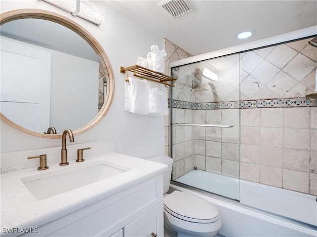 full bathroom with vanity, combined bath / shower with glass door, and toilet