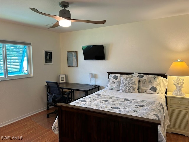 bedroom with hardwood / wood-style flooring and ceiling fan