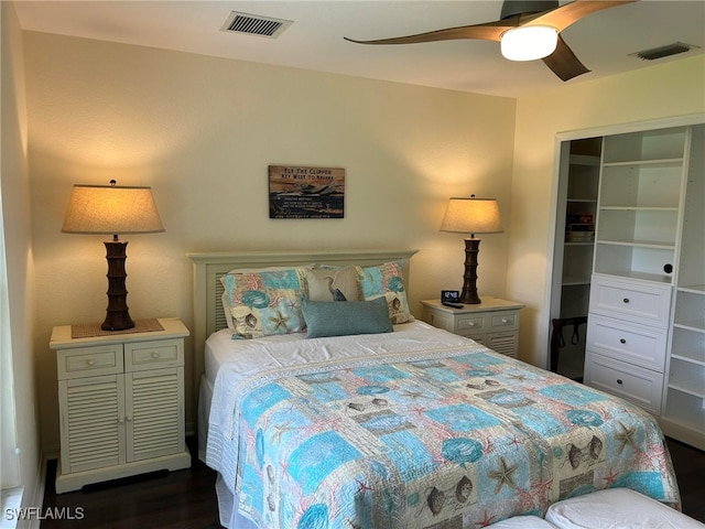 bedroom with dark wood-type flooring, a closet, and ceiling fan
