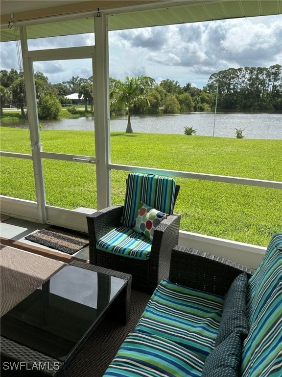 sunroom featuring a water view
