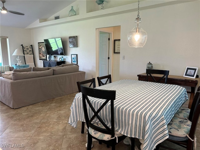 tiled dining space featuring ceiling fan, lofted ceiling, and a wealth of natural light