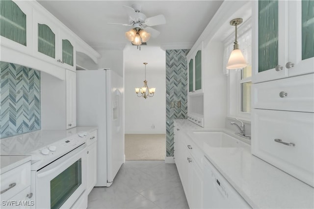 kitchen with a sink, white cabinetry, white appliances, light countertops, and hanging light fixtures