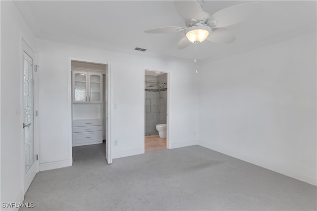 unfurnished bedroom with light carpet, connected bathroom, ceiling fan, a closet, and a spacious closet