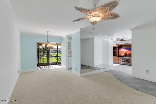 carpeted spare room featuring ornamental molding and ceiling fan with notable chandelier